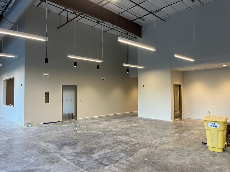 Large commercial space with acoustical ceilings and modern lighting